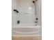 This crisp white tub and shower is accessorized with black caddy at 722 Sandy Green Ct, Fort Mill, SC 29715