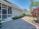 Beautifully landscaped backyard featuring a stone patio, well-maintained lawn, and mature trees for outdoor enjoyment at 815 Digby Rd, Rock Hill, SC 29730