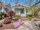 Charming home featuring a quaint porch, beautiful landscaping, and a colorful flower garden at 815 Digby Rd, Rock Hill, SC 29730