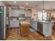 Lovely kitchen with stainless steel appliances, gray cabinets, an island, and hardwood flooring at 815 Digby Rd, Rock Hill, SC 29730