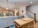Bright kitchen features a center island with white countertops and stainless steel appliances, open to the living room at 815 Digby Rd, Rock Hill, SC 29730