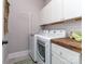 Efficient laundry room equipped with a washer, dryer, counter space, and cabinetry at 815 Digby Rd, Rock Hill, SC 29730