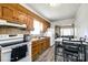 Kitchen features wood cabinets, white appliances, and a view into the living room at 970 Willowbrook Ave, Rock Hill, SC 29730