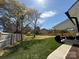 A large backyard with well-maintained grass, a wooden fence, and a covered patio at 1022 Johnna Ln, Indian Land, SC 29707