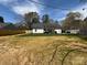 Backyard featuring a covered patio, wooden fence, and grass running to the back of the property at 1022 Johnna Ln, Indian Land, SC 29707