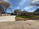 Newly renovated one-story home with green grass, long driveway and manicured lawn at 1022 Johnna Ln, Indian Land, SC 29707