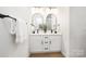Modern bathroom with double vanity, sleek black fixtures, and arched mirrors offering a minimalist aesthetic at 1026 Dooley Dr, Charlotte, NC 28227