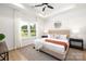 Beautifully staged bedroom with tray ceiling, neutral tones, large windows, and a ceiling fan at 1026 Dooley Dr, Charlotte, NC 28227