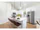 Stylish kitchen features white cabinetry, stainless steel appliances, a center island with seating, and modern finishes at 1026 Dooley Dr, Charlotte, NC 28227