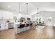 Combined kitchen and living room provides an airy, open space with an island, and stainless appliances at 1026 Dooley Dr, Charlotte, NC 28227