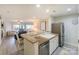 Open kitchen with modern appliances, countertop seating, and a view of the living area at 104 Pier 33 Dr # 308, Mooresville, NC 28117