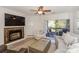Bright living room featuring a stone fireplace, a ceiling fan, and access to a private balcony at 104 Pier 33 Dr # 308, Mooresville, NC 28117