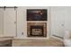 Living room featuring a decorative fireplace, sliding barn door and entry door at 104 Pier 33 Dr # 308, Mooresville, NC 28117