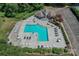 Aerial view of a refreshing community pool with lounge chairs, tables, and lush landscaping at 104 Pier 33 Dr # 308, Mooresville, NC 28117