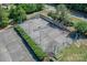 Overhead shot of a tennis court surrounded by manicured hedges and well-maintained grounds at 104 Pier 33 Dr # 308, Mooresville, NC 28117