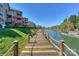 Picturesque waterfront boardwalk with rope railings, leading to boat docks with blue skies overhead at 104 Pier 33 Dr # 308, Mooresville, NC 28117