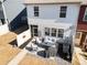 Aerial view of backyard with furniture, patio, landscaping and fence to offer privacy and a great outdoor experience at 10914 Zac Hill Rd, Davidson, NC 28036