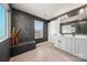 Modern bathroom with double sink vanity, glass shower, dark gray walls, and natural light at 10914 Zac Hill Rd, Davidson, NC 28036