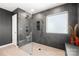 Modern bathroom featuring a glass shower, gray tile, and a sleek design at 10914 Zac Hill Rd, Davidson, NC 28036