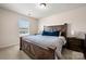 Bedroom with wood bed frame, window and neutral colored walls at 10914 Zac Hill Rd, Davidson, NC 28036