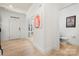 Elegant foyer with light hardwood flooring leading to a powder room and office space at 10914 Zac Hill Rd, Davidson, NC 28036