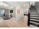Bright foyer with hardwood flooring, black staircase and entrance to the office at 10914 Zac Hill Rd, Davidson, NC 28036