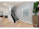 Hallway with a staircase and window, showing natural light and hardwood floors at 10914 Zac Hill Rd, Davidson, NC 28036