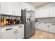 Bright kitchen featuring white cabinets, stainless steel refrigerator, and granite countertops at 10914 Zac Hill Rd, Davidson, NC 28036