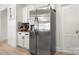 Stainless steel refrigerator adjacent to a dry bar in the kitchen area at 10914 Zac Hill Rd, Davidson, NC 28036