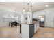 Open concept kitchen featuring island, stainless appliances, and adjacent dining area at 10914 Zac Hill Rd, Davidson, NC 28036