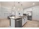 Open concept kitchen featuring an island with seating and stainless steel appliances at 10914 Zac Hill Rd, Davidson, NC 28036