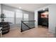 Bright upstairs landing with decorative barrel and wrought iron railing at 10914 Zac Hill Rd, Davidson, NC 28036