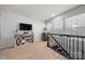 Upstairs landing with TV and decorative barrel at 10914 Zac Hill Rd, Davidson, NC 28036