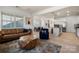Open concept living room with modern furnishings and view of kitchen and dining area at 10914 Zac Hill Rd, Davidson, NC 28036