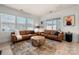 Spacious living room with natural light, leather sofas, and unique coffee table at 10914 Zac Hill Rd, Davidson, NC 28036