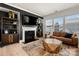 Inviting living room with modern fireplace, built-in shelves, and large windows at 10914 Zac Hill Rd, Davidson, NC 28036