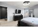 Spacious main bedroom with dark wood furniture, carpet and a wall-mounted television at 10914 Zac Hill Rd, Davidson, NC 28036