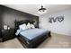 Main bedroom featuring dark accent wall, decorative art, and modern lighting at 10914 Zac Hill Rd, Davidson, NC 28036