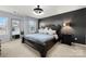 Main bedroom with dark accent wall, plush bedding, and modern lighting at 10914 Zac Hill Rd, Davidson, NC 28036