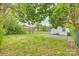 Backyard view showcasing the lawn, trees, and detached garage at 110 Steele St # 34 35, Fort Mill, SC 29715