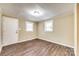 Bright bedroom with hardwood floors, neutral walls, and two windows providing natural light at 110 Steele St # 34 35, Fort Mill, SC 29715