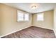 A sunny bedroom featuring laminate floors, neutral walls and two windows at 110 Steele St # 34 35, Fort Mill, SC 29715
