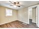Cozy bedroom with neutral walls, hardwood floors, ceiling fan and natural light at 110 Steele St # 34 35, Fort Mill, SC 29715