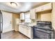A compact kitchen with white cabinetry, wood floors and black oven range at 110 Steele St # 34 35, Fort Mill, SC 29715