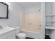Clean bathroom featuring a tub and shower, modern sink, and storage shelves at 126 E Henderson St, Salisbury, NC 28144
