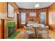 Cozy dining room features wood-paneled walls, a fireplace, and a modern table setting at 126 E Henderson St, Salisbury, NC 28144