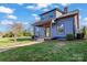 Angle view of a two-story home boasting blue siding, a covered porch with a yellow door, and a well-manicured lawn at 126 E Henderson St, Salisbury, NC 28144