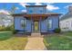 Charming two-story home showcasing blue siding, a yellow front door, and a welcoming covered front porch at 126 E Henderson St, Salisbury, NC 28144