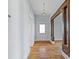 Bright hallway featuring hardwood floors, white walls, and decorative wood columns leading to the next room at 126 E Henderson St, Salisbury, NC 28144