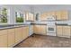 Functional kitchen with ample cabinet space, white appliances, and updated flooring at 126 E Henderson St, Salisbury, NC 28144